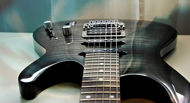 black electric guitar on table