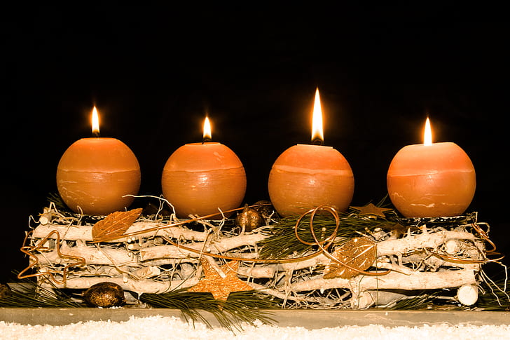 four brown pillar candles