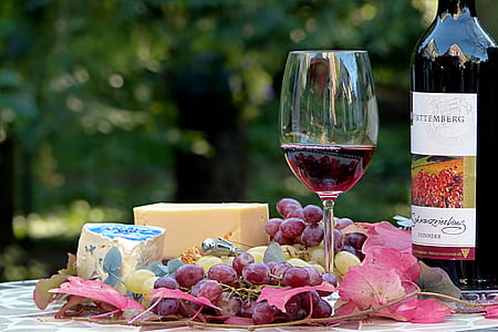 grapes with wine glass and bottle on top of table