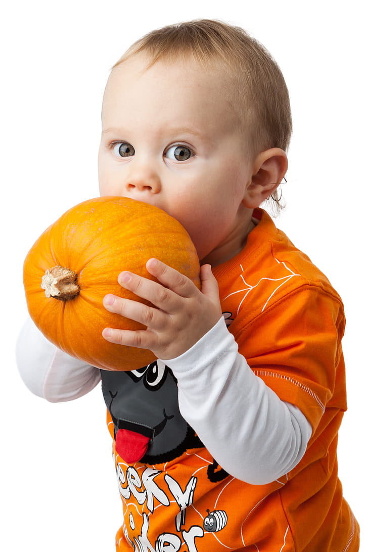 toddler about to bite pumpkin