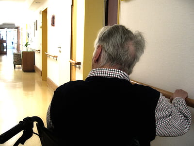 person sitting on black wheelchair white wearing black and white shirt