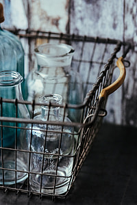 Collection of bottles in metal mesh basket