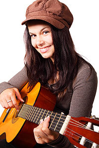 woman playing brown and black acosutic guitar
