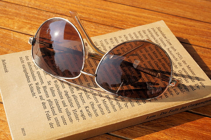 Silver Steel Framed Aviator Sunglasses on Top of Book during Daytime