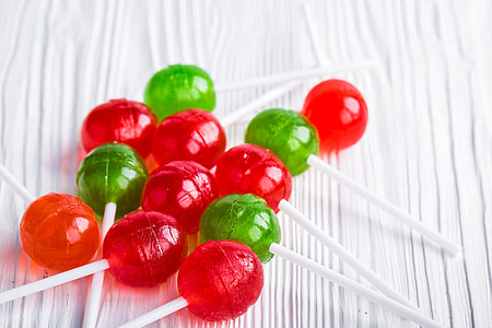 green and red lollipops on white surface