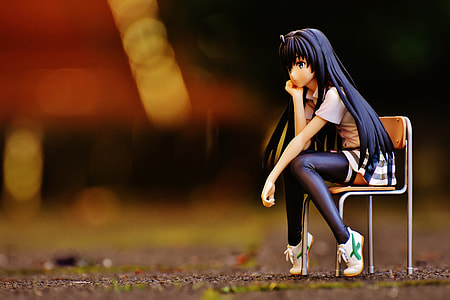 shallow focus photography of blue haired anime girl sitting on chair