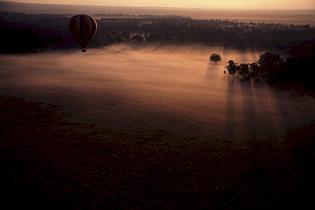 Hot Air Balloon Above Clouds during Sunset