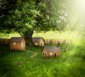 closeup photography of three miniature houses