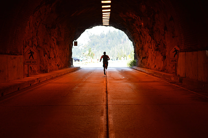 A man running/jogging in a tunnel
