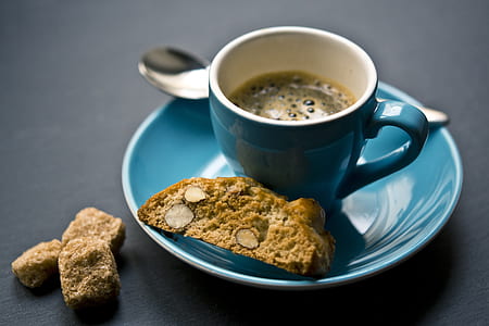 coffee in blue ceramic mug and cookie
