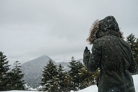person wearing black jacket in a snow season