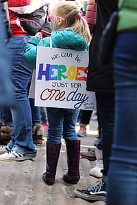 girl wearing Heroes text banner