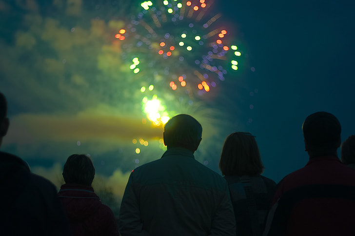 group of people watching firework display during nighttime