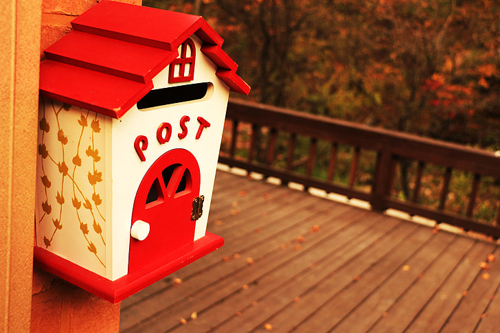 white and red wooden mailbox