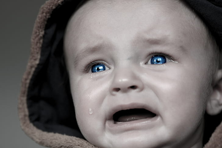 grayscale photo of baby crying wearing brown hoodie