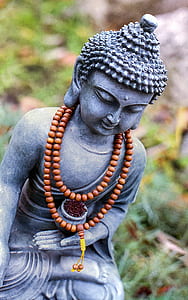 selective focus photography of gray Gautama Buddha figurine