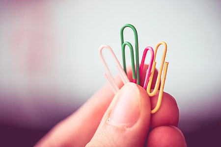 Man Holding Colorful Paper Clips