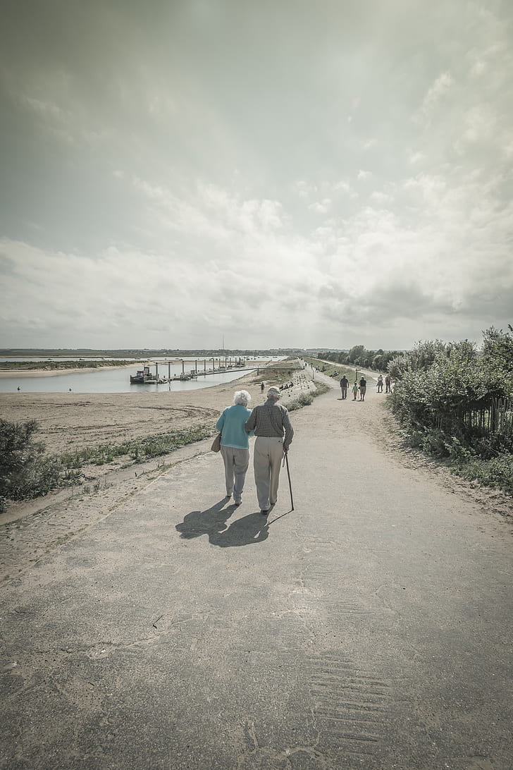 selective color of two person walking on road