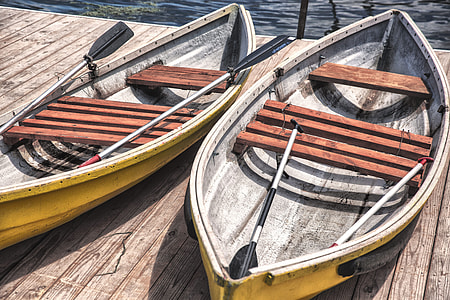 photography two yellow-and-brown wooden canoes during daytime