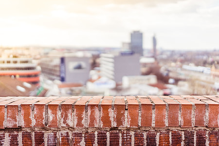 Empty Brick Wall with Blurred City View Background