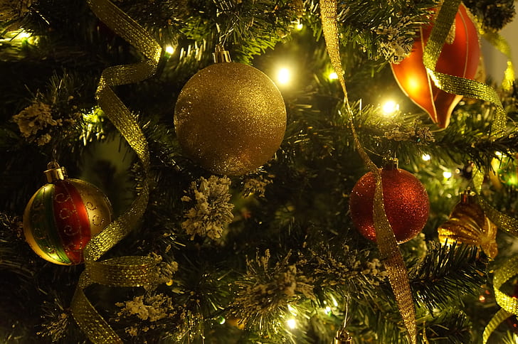 gold and red baubles hanged on Christmas tree