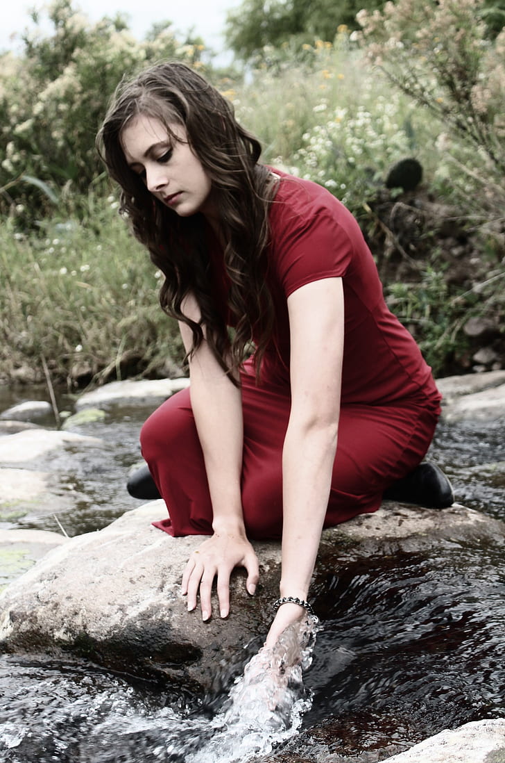 woman wearing red maxi dress on river