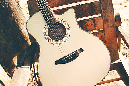 closeup photo of squared-off-cutaway acoustic guitar