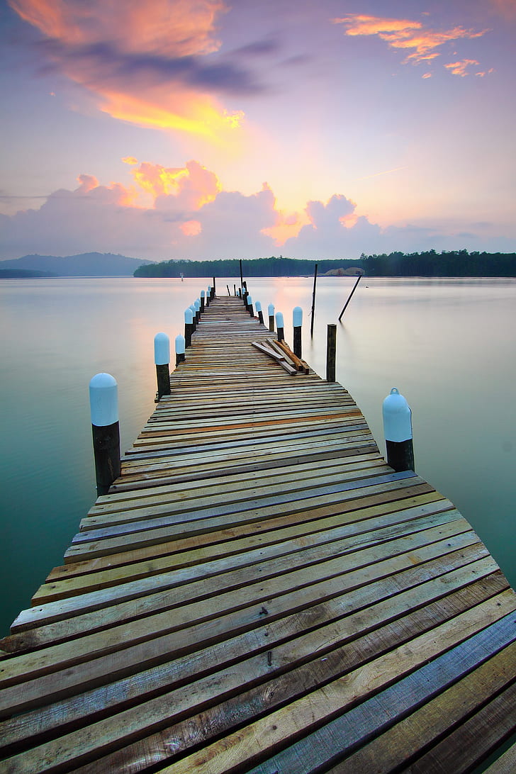 photo of brown wooden dock and body of water