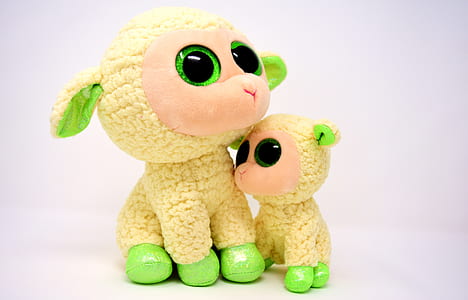 two yellow-and-green sheep plush toys