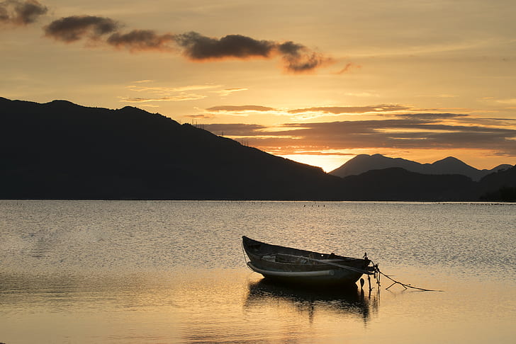 boat on body of water during sunset