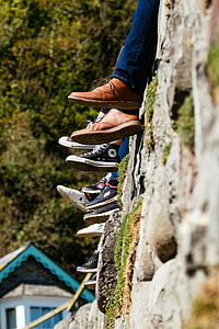 People sat on a wall - Shoes and Converse