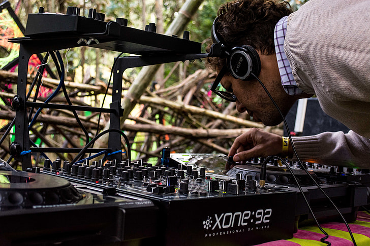 man controlling Xone 92 DJ turntable