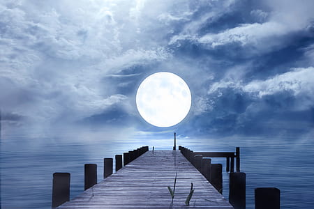 sea dock facing the ocean and full moon
