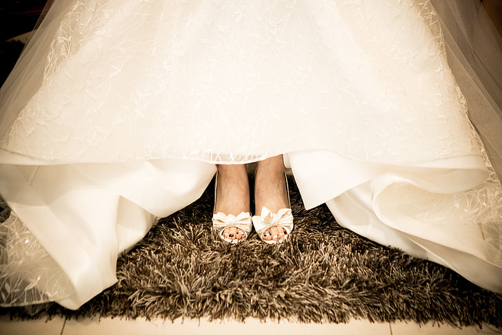 bride wearing white peep-toe heeled shoes