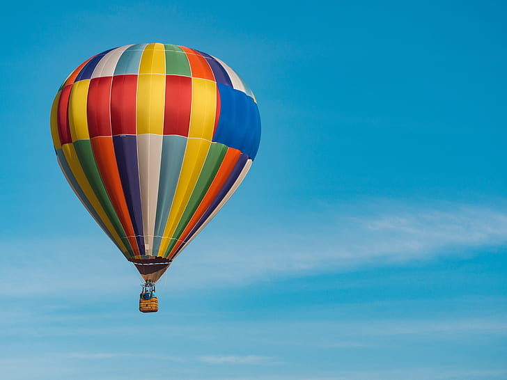 multicolored hot air balloon under cloudy sky during daytime