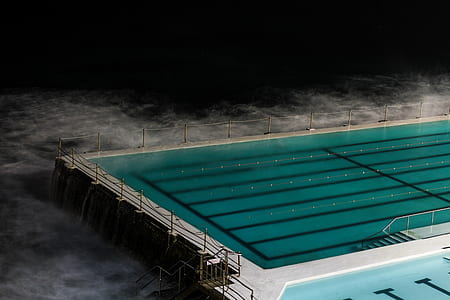 olympic size swimming pool near body of water