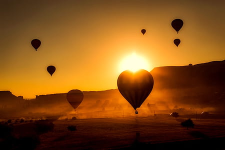 silhouette photo of hot air balloons