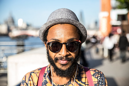 Portrait shot of a man wearing sunglasses and a hat on a sunny on the Southbank in London, image captured with a Canon 6D