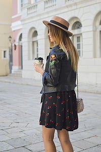 woman wearing black leather jacket and black with cherry print mini skirt