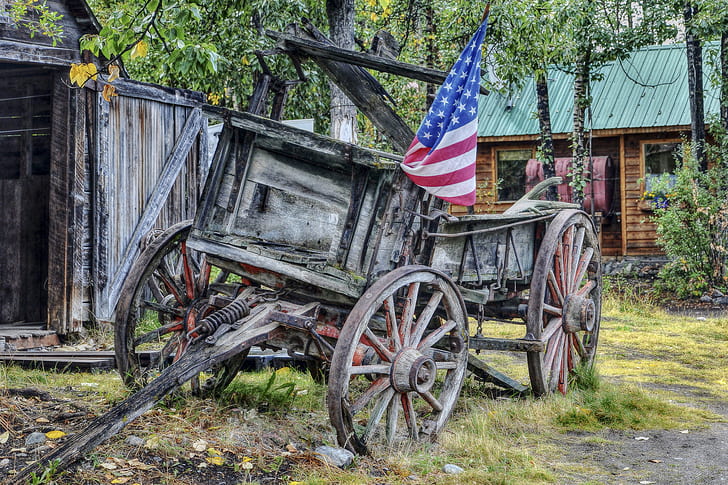 brown wooden wagon with USA flag during daytime