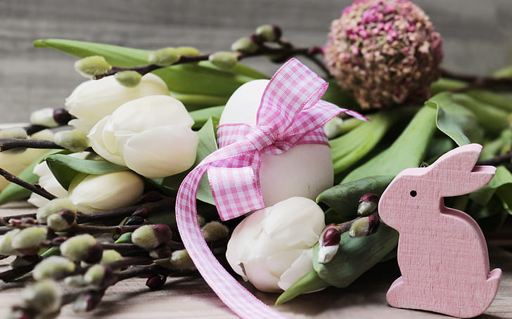 white petaled flowers beside pink rabbit figurine