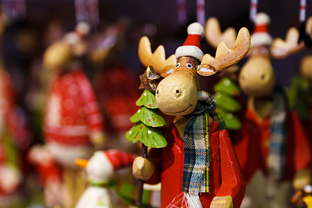 selective focus photography of wooden moose figurine