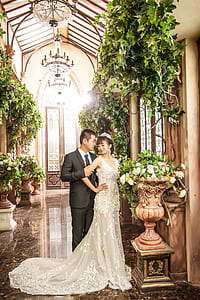 bride and groom inside church surrounded by green leaf plants