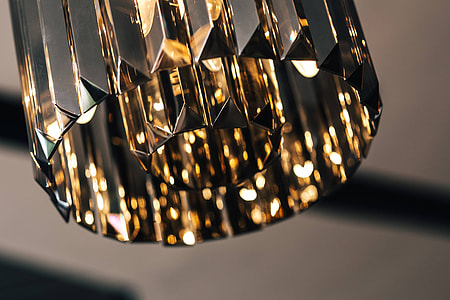 Elegant black designer chandelier with a lit lightbulb