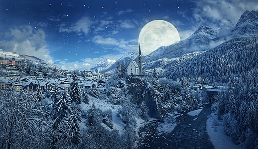 village covered with snow beside tress and mountain during full moon