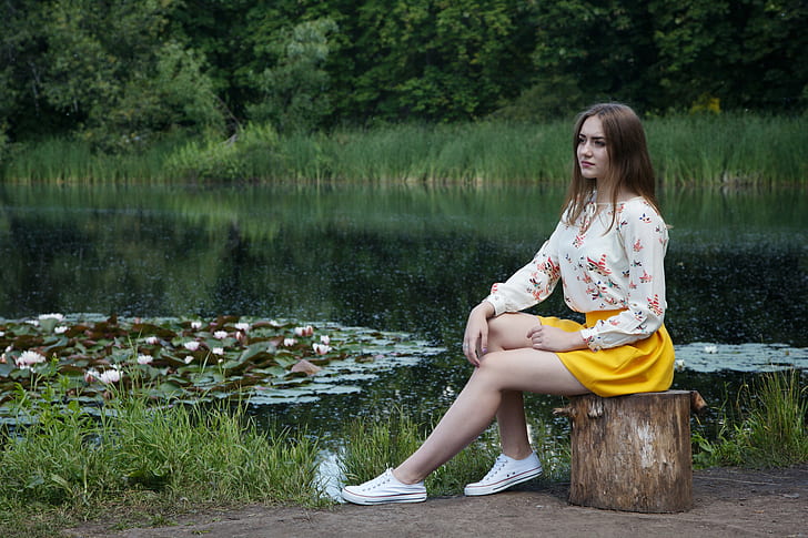 woman in white floral long-sleeved shirt and yellow mini skirt