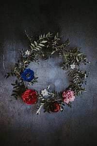 pink, red, and blue flowers on board forming wreath
