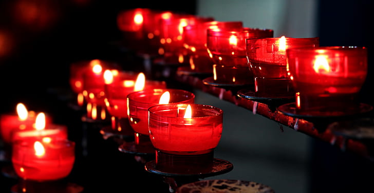 focus photography of clear glass holder with candles