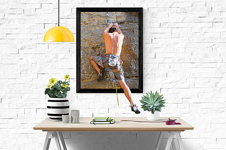 man in gray shorts painting with black wooden photo frame