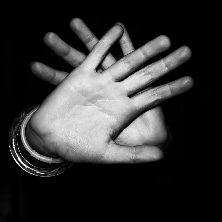 greyscale photography of humans hands